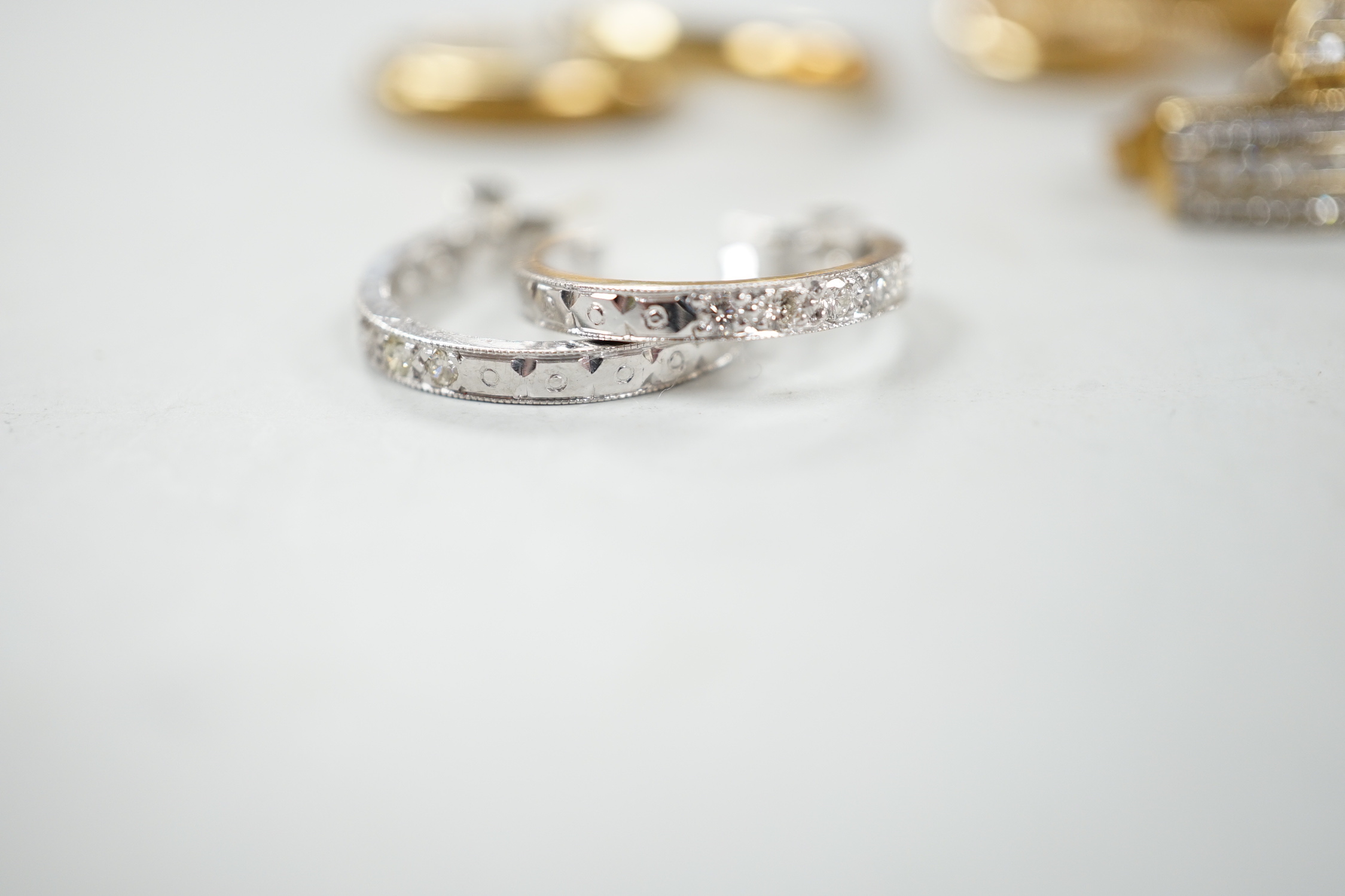 Two modern pairs of 9ct hoop or half hoop earrings and two pairs of 9ct and diamond chip set earrings including white gold, gross weight 10.9 grams.